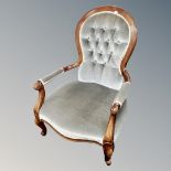 A Victorian style open armchair in buttoned dralon