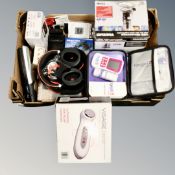A box containing electricals including Gabra headphones, a Visage ultrasonic pain massager,