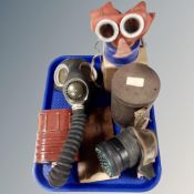 A tray containing vintage gas masks.