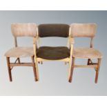 A 20th century light-oak armchair together with two plywood dining room chairs.