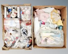 Two boxes containing a large quantity of vintage doll's clothes and shoes.