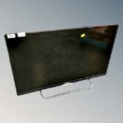 A Polaroid 32" LED TV with remote.