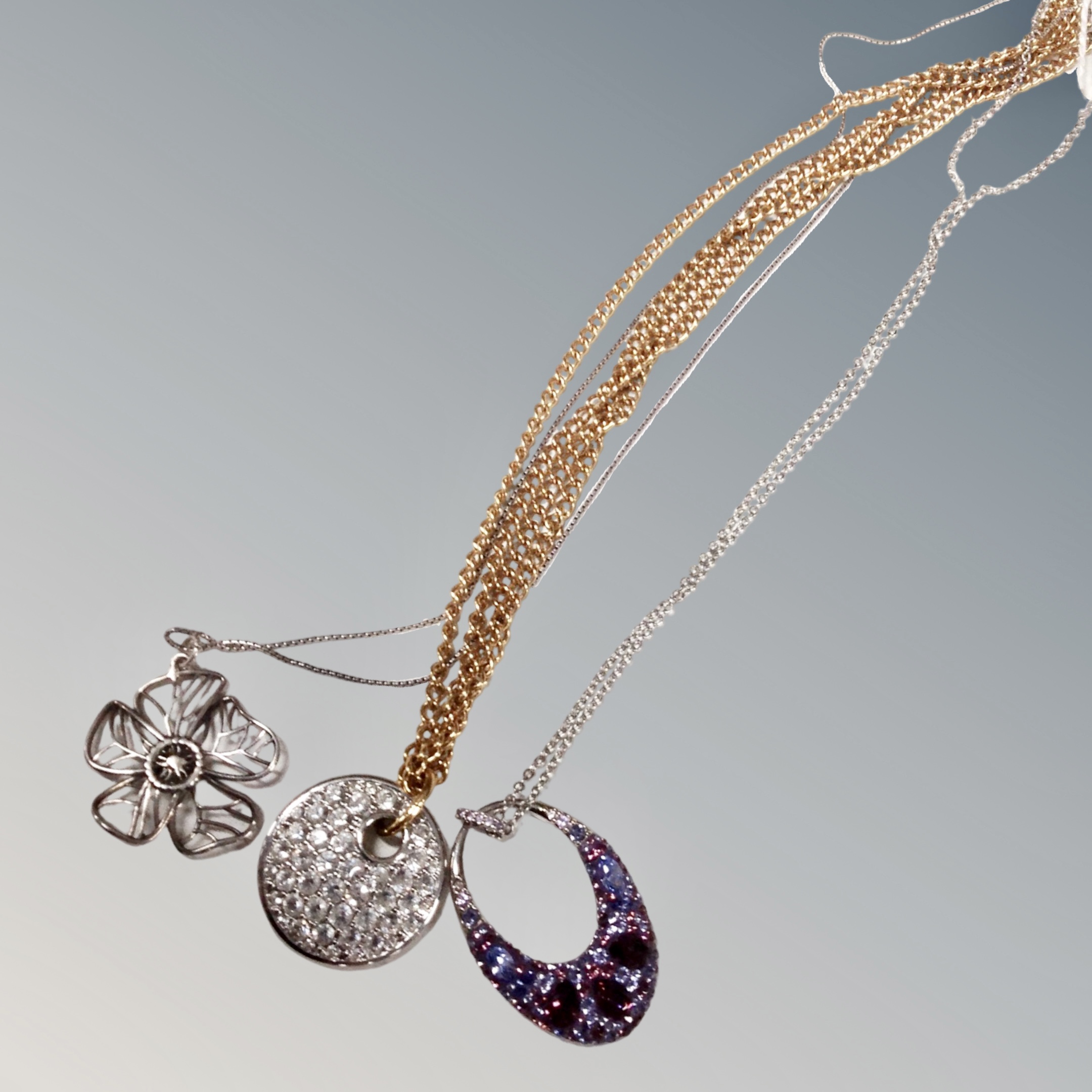 A solid silver magnolia pendant and chain together with a Swarovski chain with encrusted lavender