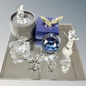 A mirrored stand together with eight Swarovski crystal animal figures and paperweights.