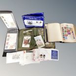 A box containing a Herald stamp album containing antique and later stamps,