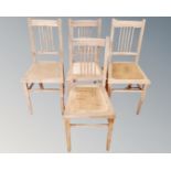 A set of four beech rail backed dining room chairs.