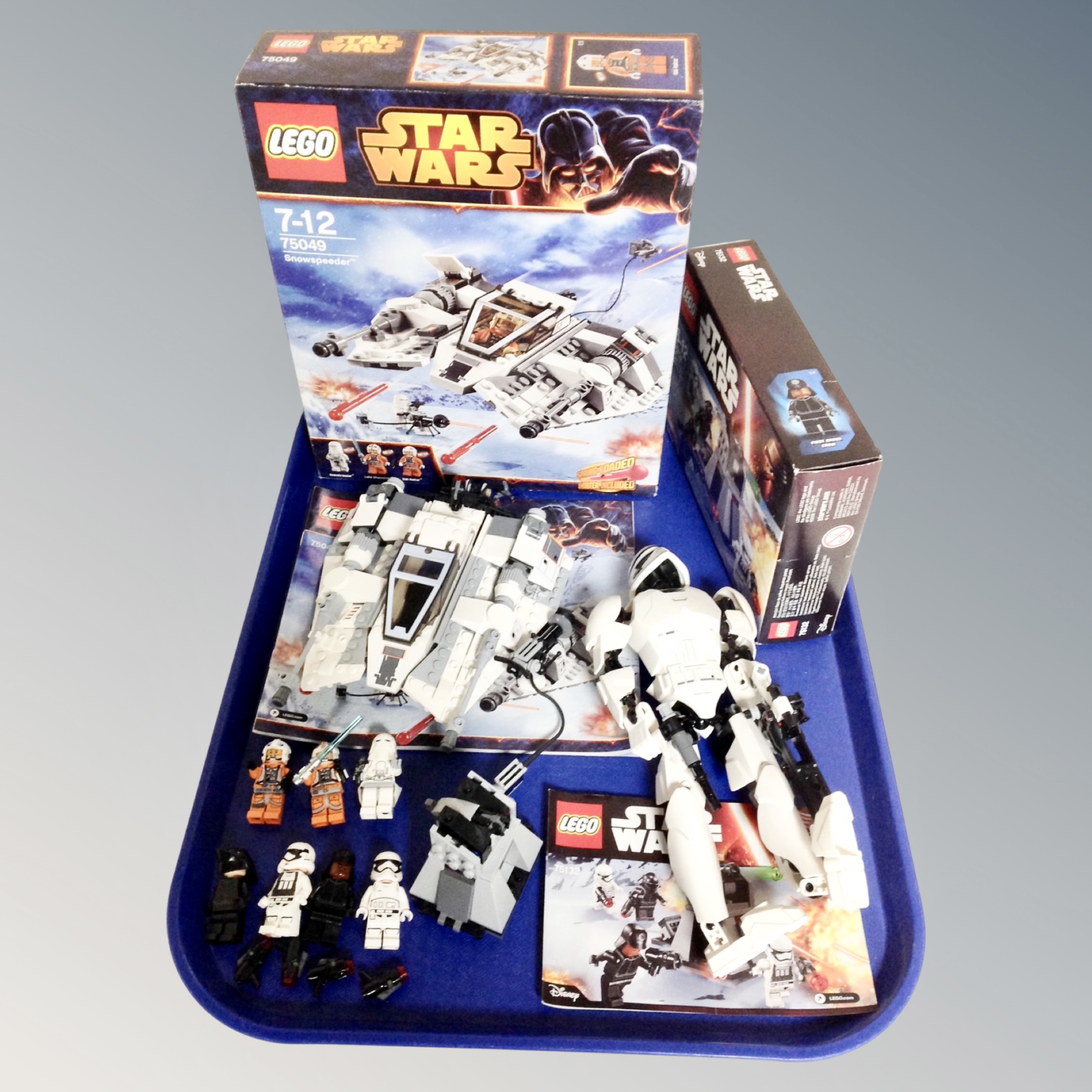 A Lego Star Wars 75049 Snow Speeder together with a Lego Star Wars 75132 First Order Battlepack,