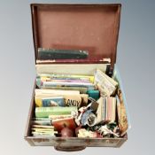 A vintage luggage case containing children's books including Andy Capp, Ladybird, pocket volumes,
