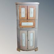 A continental painted bow fronted corner cabinet.