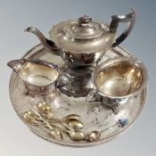 A three piece plated tea service on circular tray,