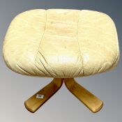 A tan leather footstool.
