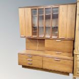 A mid-20th century teak cocktail wall unit, fitted with cupboards and drawers,