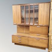 A mid-20th century teak cocktail wall unit, fitted with cupboards and drawers,