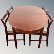 A 20th century Nathan oval extending dining table fitted with a leaf, together with four chairs.
