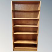 A set of Scandinavian open bookshelves in a teak finish.