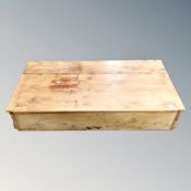 An antique pine under bed storage box.