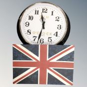 A wall clock and a Union Jack picture