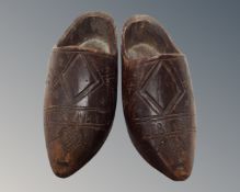 A pair of antique wooden miniature clogs