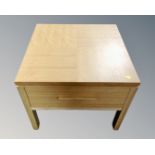 A contemporary oak lamp table fitted a drawer