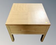 A contemporary oak lamp table fitted a drawer