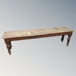 A 19th century pine bench.