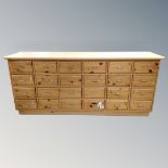 A pine 24 drawer block chest.