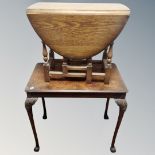 An Edwardian walnut occasional table on claw and ball feet together with a further flap sided