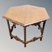 A 20th century oak hexagonal occasional table on carved barley twist supports.