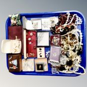 A tray of costume jewellery including necklaces, brooches, cuff links etc.
