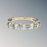 A 9ct yellow gold synthetic aquamarine half eternity ring, size N/O, 2.6g.