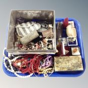 A tray of costume jewellery, a tin of beads, spectacles, brooches etc.