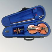 A child's violin with bow, in case.