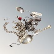 A collection of silver and white metal items including teaspoons, a chain, necklaces, pendants,