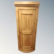 A 19th century pine bow front single door wall cabinet.