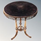 An early 20th century carved beech wood circular occasional table.