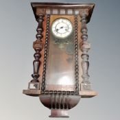 An antique eight day wall clock.