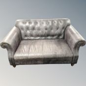 A buttoned leather upholstered club settee.