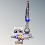 A Dyson small ball vacuum together with a Dyson handheld vacuum.