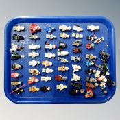 A tray containing a quantity of Lego Star Wars advent calendar minifigures and accessories.