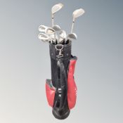 A golf bag containing a set of Pin High irons and oversized drivers.
