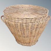 A vintage wicker lidded twin handled basket.