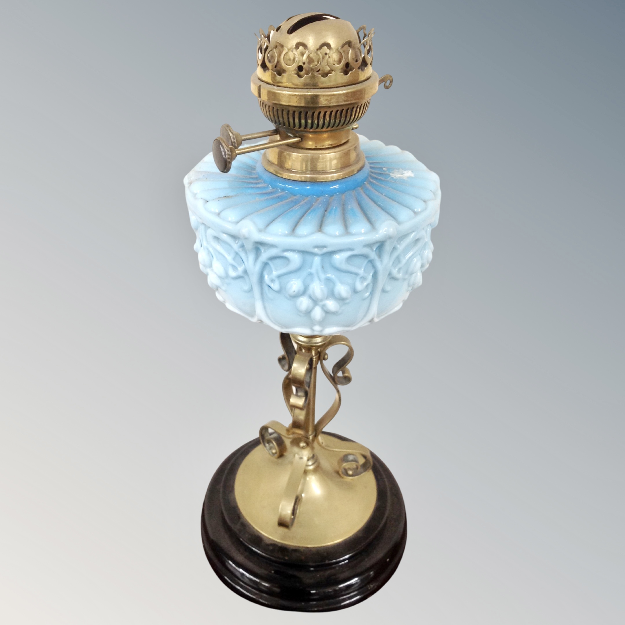 A Victorian oil lamp with blue glass reservoir.