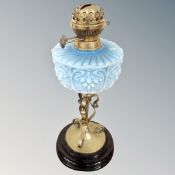 A Victorian oil lamp with blue glass reservoir.