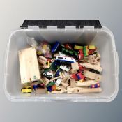 A box of wooden building blocks, a wooden child's vehicle set.