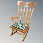 A beech farmhouse style rocking chair.