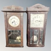 Two early 20th century eight day wall clocks with silvered dials.