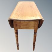 A 19th century pine flap sided table.