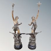 A pair of spelter figures on plinths.