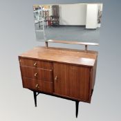 A mid-20th century three drawer dressing table fitted with a cupboard in a teak finish.