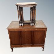 A 20th century oak panelled blanket box together with a nest of three tables.